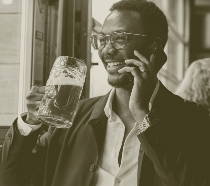 a man with a beer and a phone